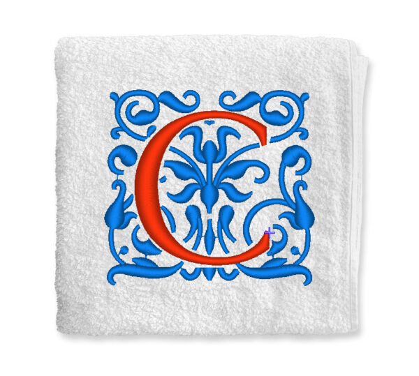 díszes iniciálé hímezve